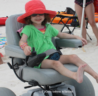 little kate enjoying a dune busting time on a motorized beach wheel chair